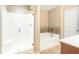 Bathroom with a glass-enclosed shower, soaking tub, tiled accents, and a neutral color palette at 198 Britt Dr, Lawrenceville, GA 30046