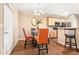 Bright dining area showcasing a modern glass table, stylish chairs, and a view into the kitchen at 198 Britt Dr, Lawrenceville, GA 30046