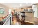 Well-designed kitchen with barstool seating, stainless steel appliances, granite countertops, and ample cabinet space at 198 Britt Dr, Lawrenceville, GA 30046