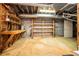 Unfinished basement featuring wooden shelves and a utility door at 1373 Janice Sw Ct, Lilburn, GA 30047
