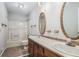 Bathroom featuring double vanity, tub shower and oval mirrors at 1373 Janice Sw Ct, Lilburn, GA 30047