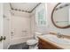 Cozy bathroom with tub shower, decorative wall paper and decorative window curtain at 1373 Janice Sw Ct, Lilburn, GA 30047
