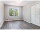 Neutral bedroom with gray walls, wood flooring and double door closet at 1373 Janice Sw Ct, Lilburn, GA 30047