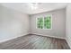 Neutral bedroom with gray walls and beautiful natural light from the large window at 1373 Janice Sw Ct, Lilburn, GA 30047