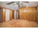 Bedroom featuring unfinished flooring and wood paneling walls at 1373 Janice Sw Ct, Lilburn, GA 30047