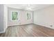 Inviting bedroom with hardwood floors, neutral paint, and large windows offering plenty of natural light at 1373 Janice Sw Ct, Lilburn, GA 30047