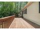 Long wooden deck with a railing, offering views of the surrounding trees and greenery at 1373 Janice Sw Ct, Lilburn, GA 30047