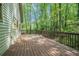 Spacious wooden deck surrounded by lush trees, ideal for outdoor entertaining at 1373 Janice Sw Ct, Lilburn, GA 30047