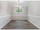 Dining room featuring hardwood floors, modern lighting, and ample space for entertaining guests with plenty of natural light at 1373 Janice Sw Ct, Lilburn, GA 30047