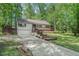 Charming home with a deck, featuring mature trees and a well-maintained front yard and an attached garage at 1373 Janice Sw Ct, Lilburn, GA 30047