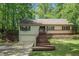 Charming home with a deck, featuring mature trees, a well-maintained front yard and an attached garage at 1373 Janice Sw Ct, Lilburn, GA 30047