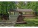 Charming home with a deck, featuring mature trees, a well-maintained front yard and an attached garage at 1373 Janice Sw Ct, Lilburn, GA 30047