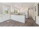 Modern kitchen featuring white cabinets, stainless steel appliances, and an eat-in bar area with hardwood floors at 1373 Janice Sw Ct, Lilburn, GA 30047
