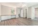 Bright main bedroom features a built-in vanity, modern ceiling fan, and gray wood flooring at 1373 Janice Sw Ct, Lilburn, GA 30047