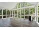 Bright sunroom with hardwood floors and floor to ceiling windows, providing a scenic view of the surrounding nature at 1373 Janice Sw Ct, Lilburn, GA 30047