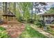 Backyard with a stone pathway, gazebo, screened porch, and meticulously maintained landscaping at 1631 Manhasset Dr, Atlanta, GA 30338