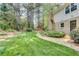 Lush backyard with stone pathway leading to a gazebo; mature trees and landscaped features at 1631 Manhasset Dr, Atlanta, GA 30338
