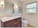 Half-bath featuring a cherry cabinet, white countertop, and brushed nickel faucet at 1631 Manhasset Dr, Atlanta, GA 30338