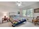 Cozy bedroom featuring a colorful quilt, ceiling fan and natural light from a window at 1631 Manhasset Dr, Atlanta, GA 30338