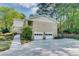 Home exterior featuring a two-car garage and meticulously landscaped yard and walkway at 1631 Manhasset Dr, Atlanta, GA 30338