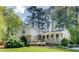 Charming two-story brick home with a well-manicured lawn and mature trees at 1631 Manhasset Dr, Atlanta, GA 30338