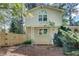 Back of a brick home with a small deck and a wooden privacy fence at 1631 Manhasset Dr, Atlanta, GA 30338