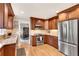 Well-lit kitchen featuring stainless steel appliances, granite countertops, and wood cabinets at 1631 Manhasset Dr, Atlanta, GA 30338