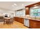 Bright and open kitchen featuring hardwood floors, granite countertops, and stainless steel dishwasher at 1631 Manhasset Dr, Atlanta, GA 30338