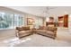 Cozy living room featuring lots of light, neutral paint, and access to the kitchen at 1631 Manhasset Dr, Atlanta, GA 30338