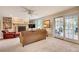 Bright living room with fireplace, built-in shelves, and access to outdoor patio at 1631 Manhasset Dr, Atlanta, GA 30338