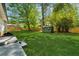 Spacious, level backyard features lush green grass and a charming storage shed at 1737 Briarlake Cir, Decatur, GA 30033