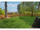 Lush backyard bordered by a wooden fence and mature trees, with lots of sunlight at 1737 Briarlake Cir, Decatur, GA 30033