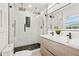 Modern bathroom boasts a dual sink vanity and glass shower with sleek, upscale finishes at 1737 Briarlake Cir, Decatur, GA 30033