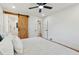 Bedroom featuring a sliding barn door to the bathroom, bed, and a modern ceiling fan at 1737 Briarlake Cir, Decatur, GA 30033