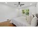 Cozy bedroom with hardwood floors, two windows, a queen bed, and a modern ceiling fan at 1737 Briarlake Cir, Decatur, GA 30033