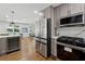 Open kitchen concept with stainless steel appliances, a wine fridge and views to the dining and living areas at 1737 Briarlake Cir, Decatur, GA 30033