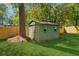 Green shed in the backyard provides extra storage with space for gardening tools at 1737 Briarlake Cir, Decatur, GA 30033