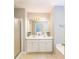 Bright bathroom featuring a double vanity, framed mirror, and shower/tub combo at 3140 Ennfield Ln, Duluth, GA 30096