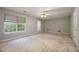 A spacious bedroom with a ceiling fan, a window, and a door at 3140 Ennfield Ln, Duluth, GA 30096