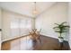 Sunlit dining room with hardwood floors, vaulted ceiling, and a cozy ambiance for intimate gatherings at 3140 Ennfield Ln, Duluth, GA 30096