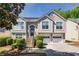 Charming two-story home featuring a two-car garage, manicured lawn and stone staircase, perfect for suburban living at 3140 Ennfield Ln, Duluth, GA 30096