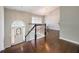 Inviting foyer with hardwood floors, staircase, and an arched doorway that leads into a sunlit dining area at 3140 Ennfield Ln, Duluth, GA 30096