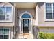 Close up of a beautiful home's front door with decorative glass, elegant sidelights and stylish exterior lighting at 3140 Ennfield Ln, Duluth, GA 30096