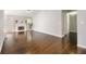 Open-concept living room with hardwood floors, a cozy fireplace, and an inviting atmosphere for relaxation at 3140 Ennfield Ln, Duluth, GA 30096