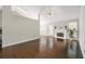 Open living room features a fireplace, ceiling fan and dark wood floors at 3140 Ennfield Ln, Duluth, GA 30096