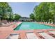 Community pool surrounded by lounge chairs and lush greenery, perfect for summer relaxation and recreation at 3140 Ennfield Ln, Duluth, GA 30096