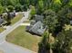 Aerial view of a home with a lush lawn and mature trees in a suburban neighborhood at 7171 Hazelwood Dr, Jonesboro, GA 30236