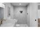 Bathroom featuring updated tile shower, gold fixtures, and modern design at 7171 Hazelwood Dr, Jonesboro, GA 30236