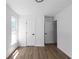 A bright bedroom featuring hardwood floors, white walls, and natural light from the window at 7171 Hazelwood Dr, Jonesboro, GA 30236