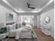Stylish bedroom featuring a ceiling fan, tray ceiling, and wood flooring at 7171 Hazelwood Dr, Jonesboro, GA 30236